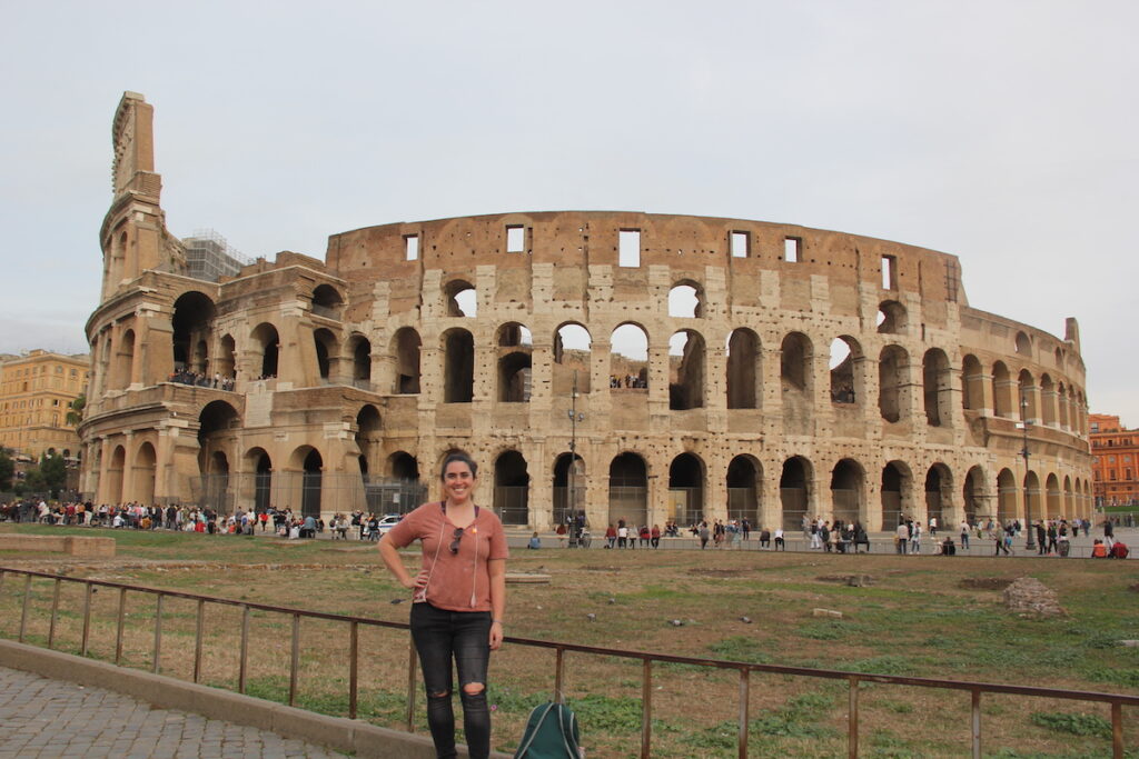 With the best travel photo tours in Rome, you can get professional photos in front of all the most iconic, and off-the-beaten-path places! This photo is Sarah in front of the Colosseum.