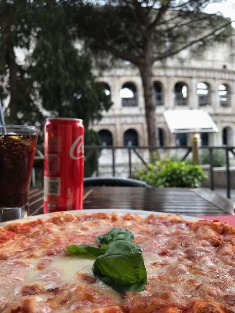 Amazing pizza with a view of the Colosseum in Rome, Italy!