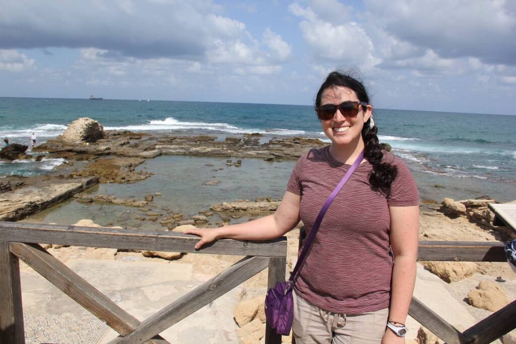 Sarah standing in front of Herod's Palace remains in the Mediterranean Sea at Caesarea