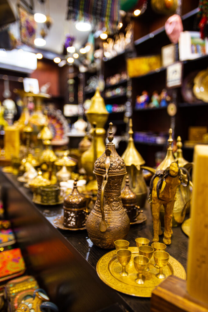A souvenir shop in Amman with gold items like coffee pots and figurines