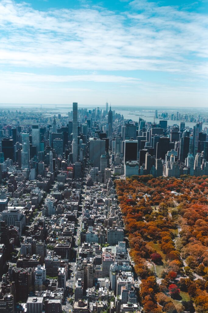 Aerial photo over Manhattan, New York City in the fall with the colorful trees of Central Park in the right side of the photo