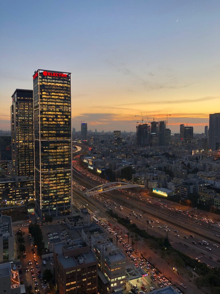 Tel Aviv, Israel at sunset from a high-up view in the center, with the roads and traffic in view