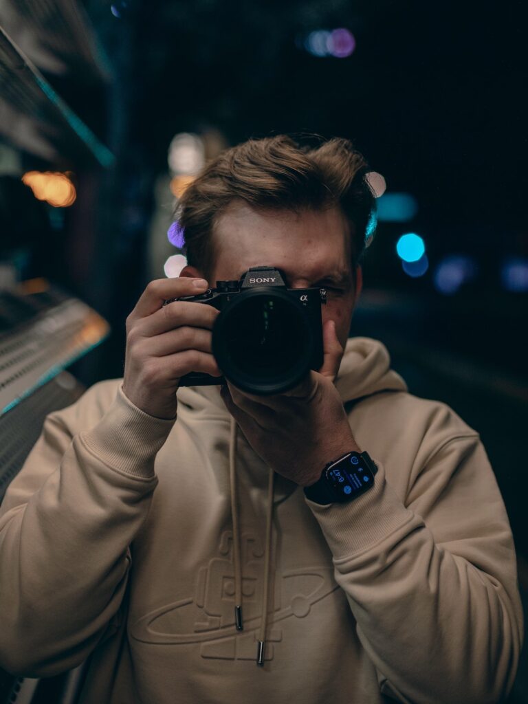 Travel photographer taking a photo with the Sony A7 IV - looking straight at the photographer